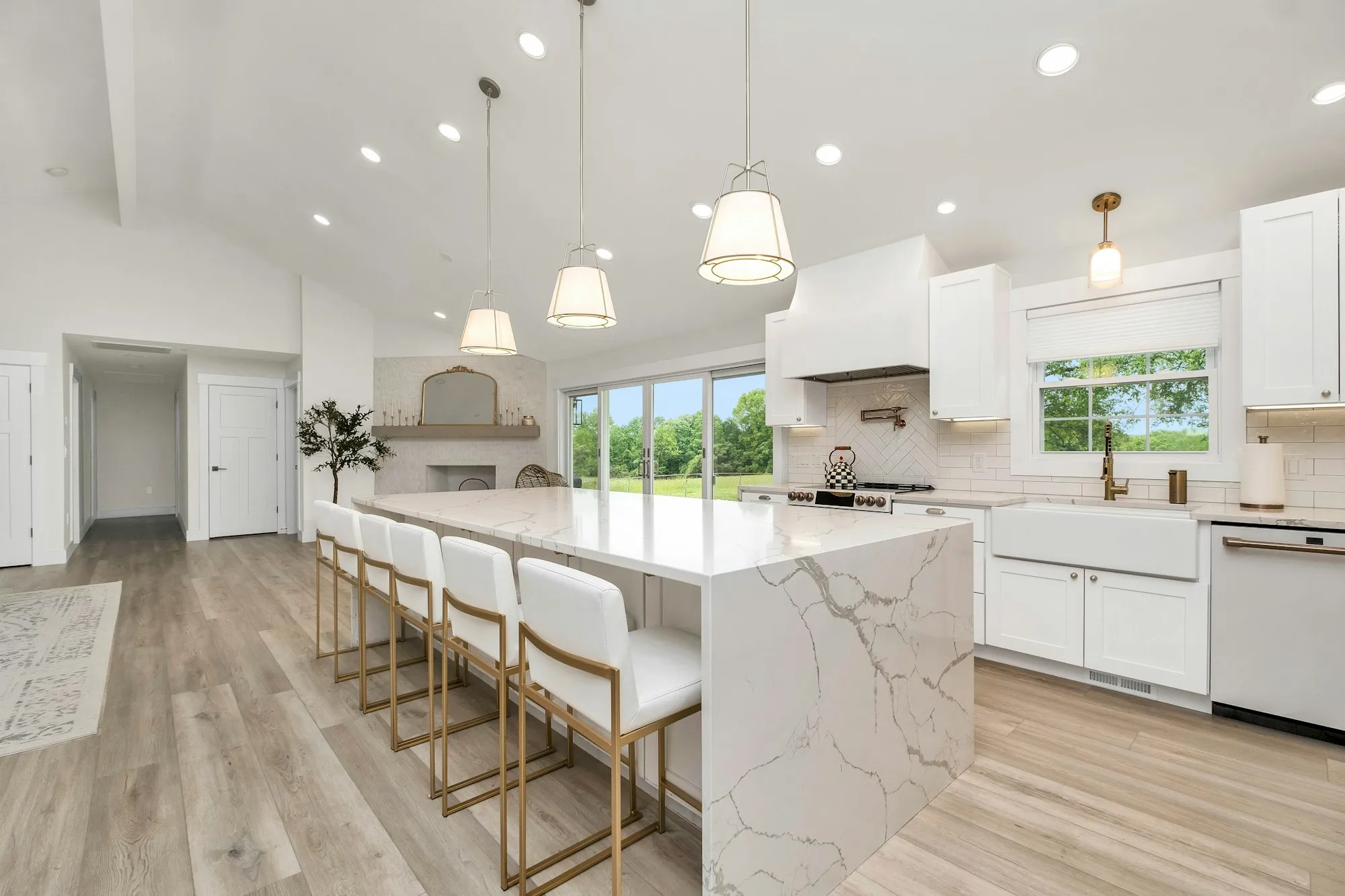 A bright white kitchen with a quartz island