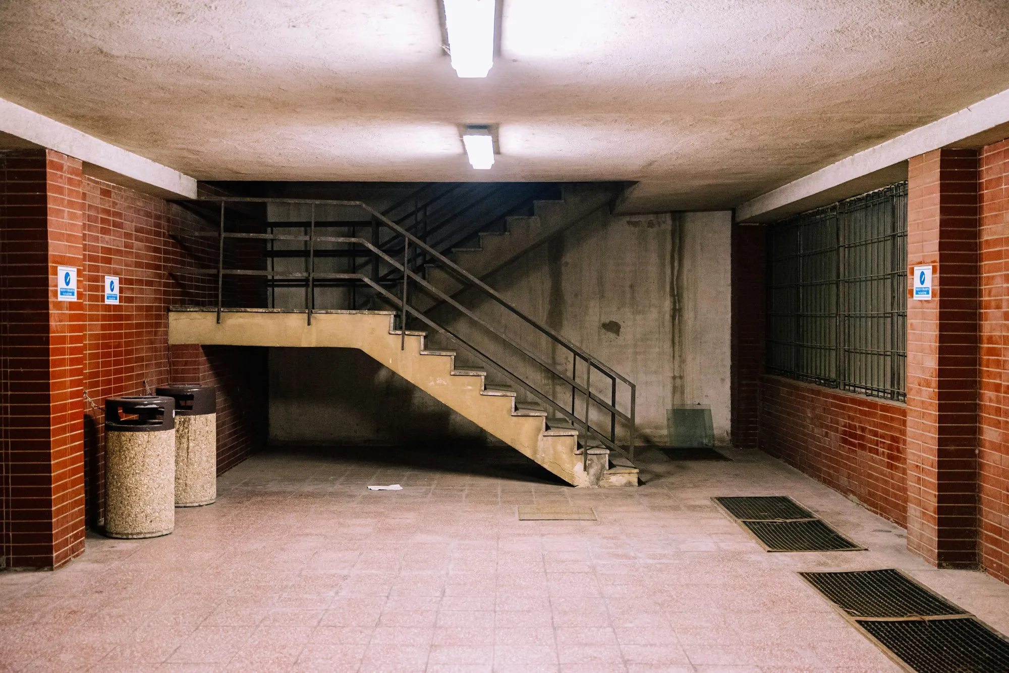 A basement staircase with a steel handrail