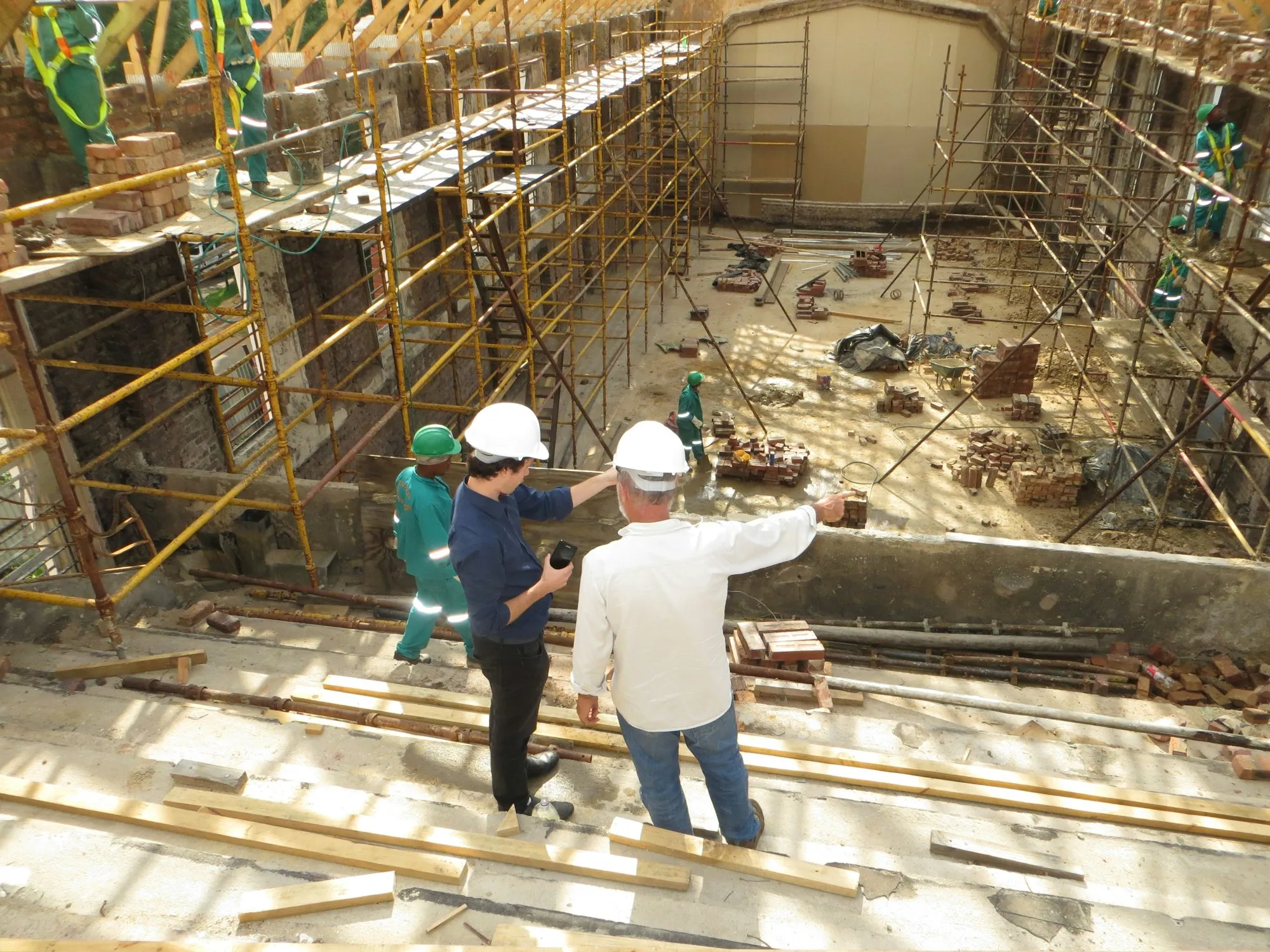 Two site supervisors reviewing work in progress