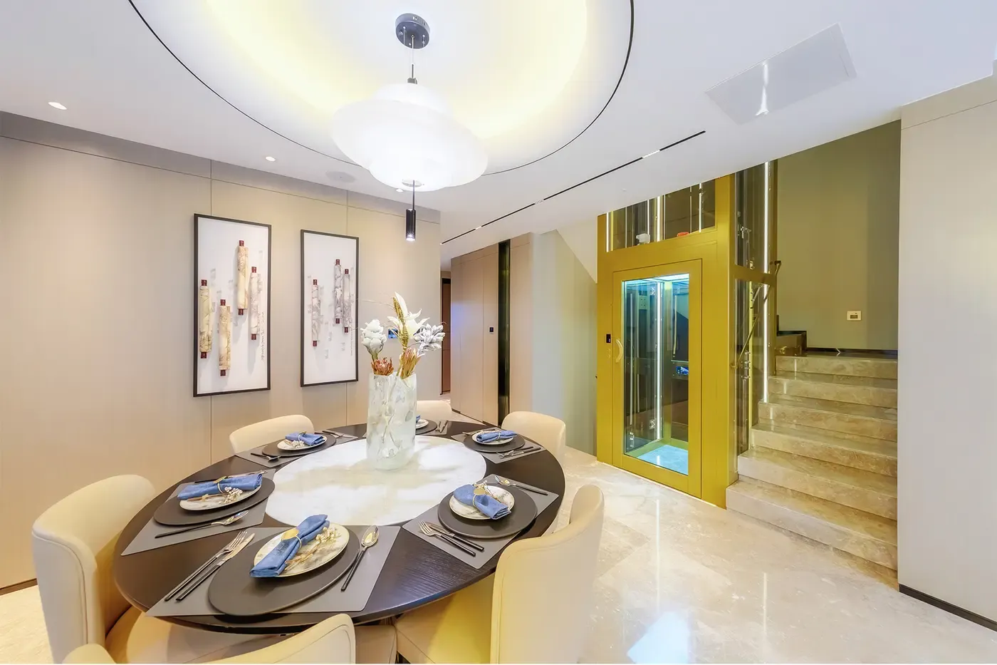 Gold-framed glass home elevator next to a dining room