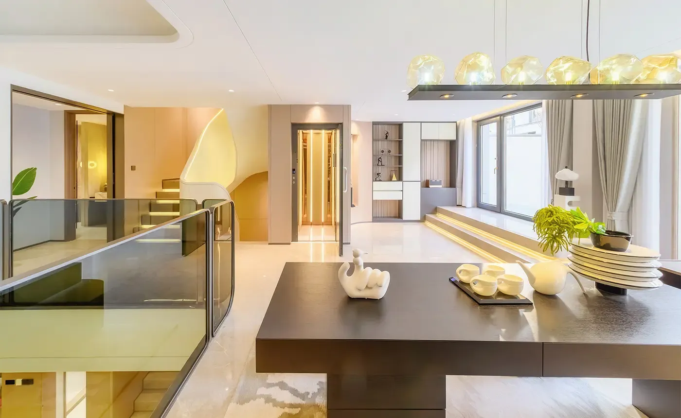 Glass home elevator in an open-plan living and dining area